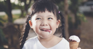 Girl eating a vanilla ice cream cone