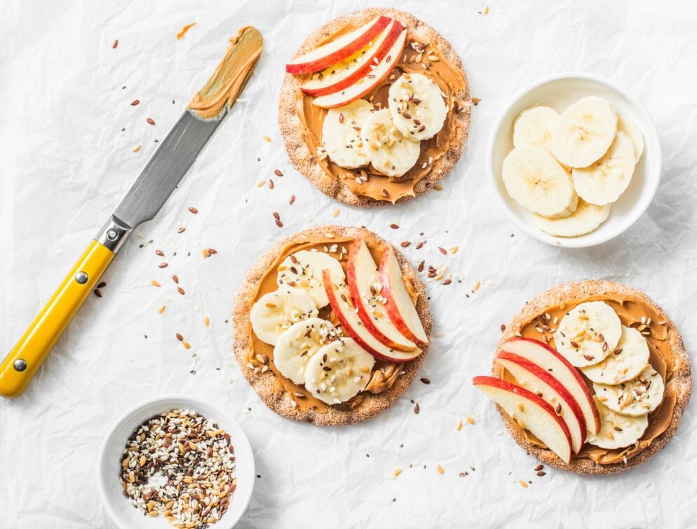 Why You Should Take a Closer Look at Your Kids’ Snacks Cut fruits and peanut butter on crackers