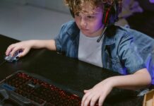 A young boy plays video games on the computer.