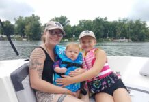 A mom and her two kids have fun on a lake