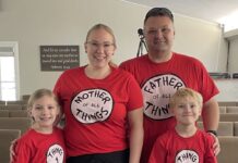 Julie Redmond, her husband and her two children wear matching red Dr. Seuss themed shirts.