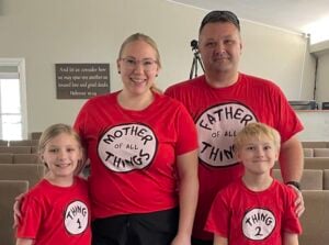 Julie Redmond, her husband and her two children wear matching red Dr. Seuss themed shirts.