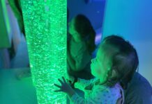 A child looks at a glowing tube