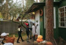 Three kids in Halloween costumes trick-or-treating