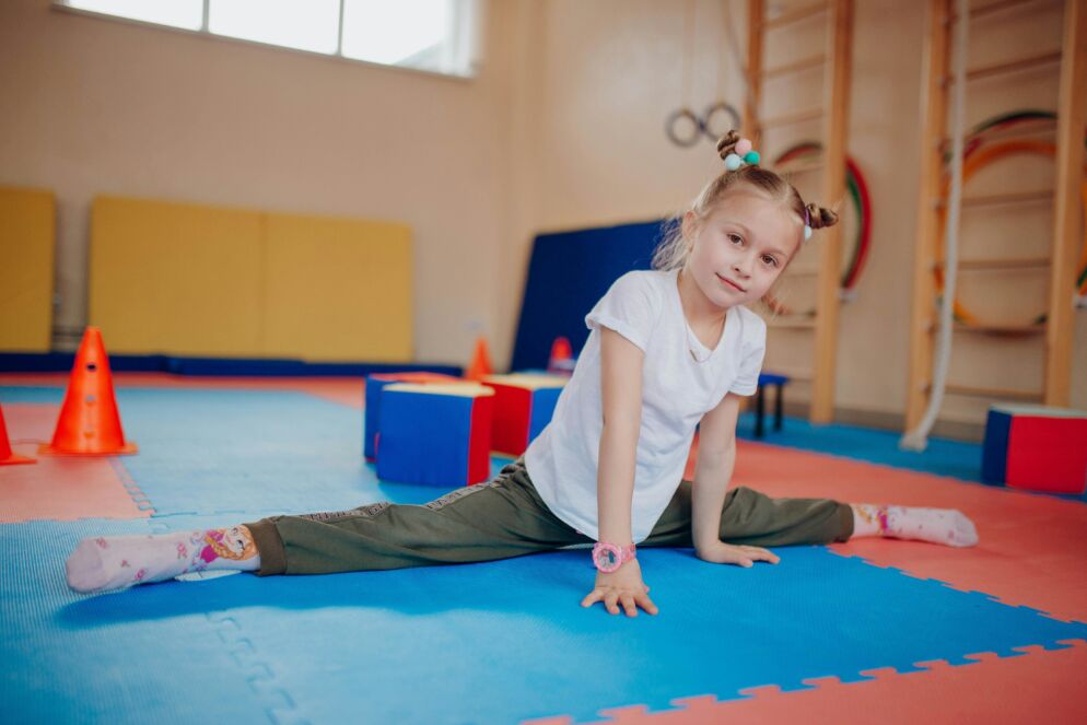 Girl in a gymnastics studio doing a split