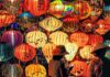 A woman standing in front of a display of lanterns at the Mid-Autumn Festival
