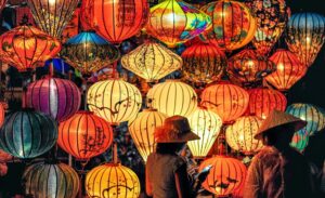 A woman standing in front of a display of lanterns at the Mid-Autumn Festival