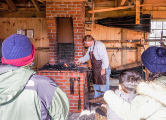 Holiday Happenings in Frederick People watching a blacksmith working