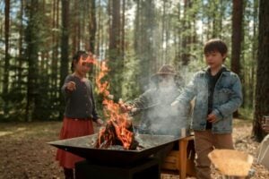 Children sitting by a campfire