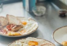 Three plates of breakfast food