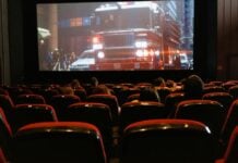 People in a movie theater watching a movie