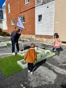 Children looking at a mini golf course made of ice