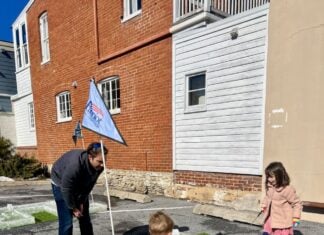Children looking at a mini golf course made of ice