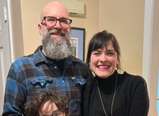 A family standing in front of a door