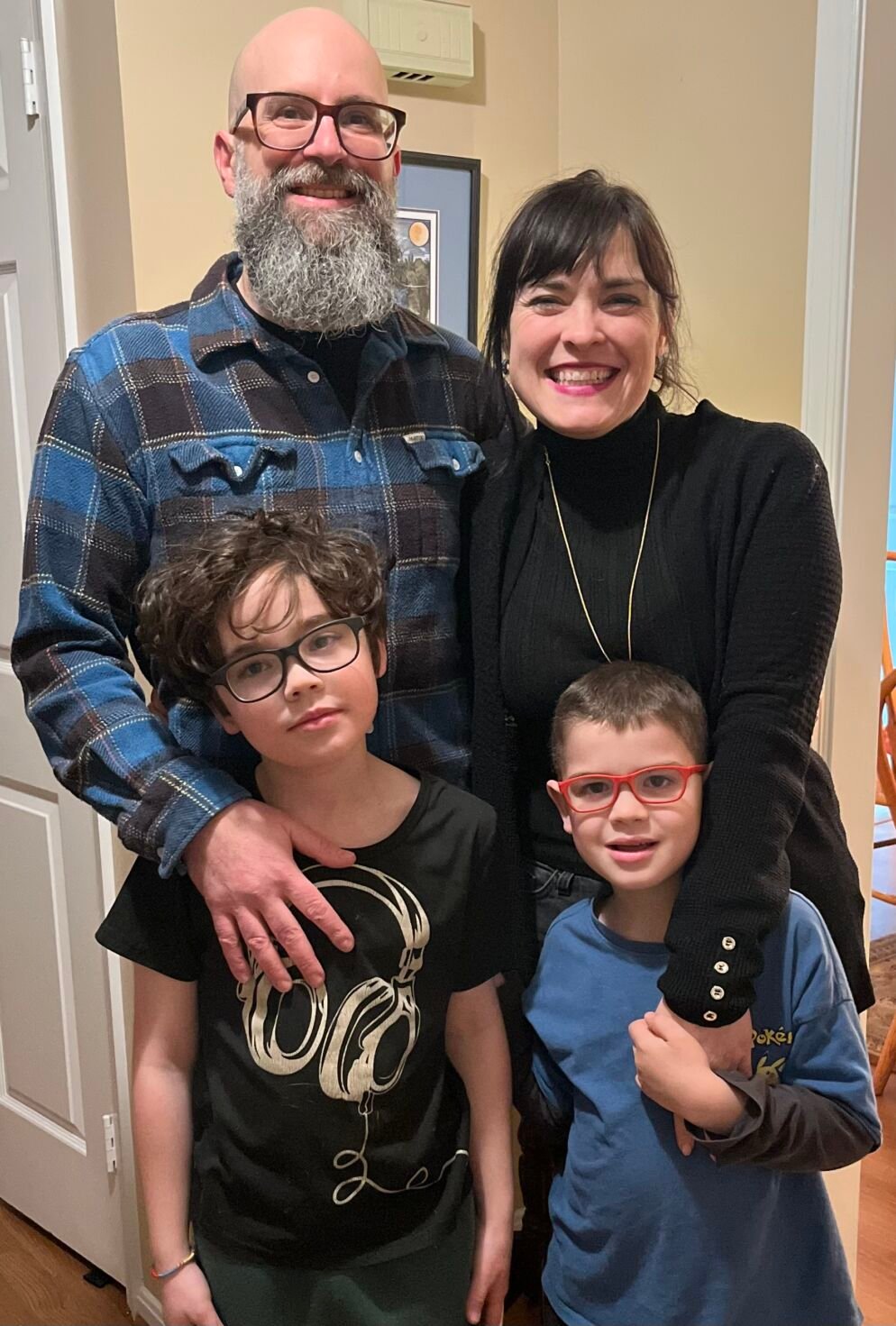 A family standing in front of a door