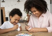A mother and son painting eggs