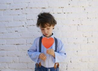 Boy holding a paper heart