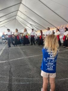 A girl watches dancers at the Frederick Greek Festival