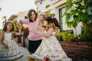 A mother dancing with her two daughters