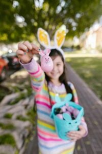 A child holds up an Easter egg