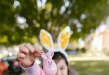 A child holds up an Easter egg