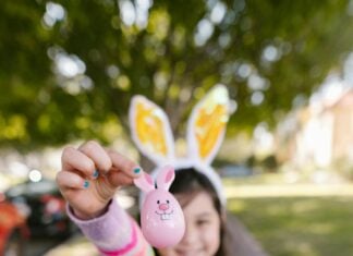 A child holds up an Easter egg