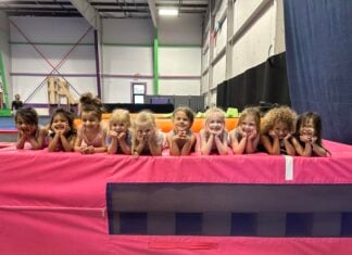 Gymnastics students lined up on a mat