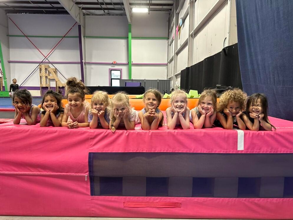Gymnastics students lined up on a mat