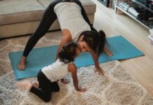 A mother doing yoga with her daughter