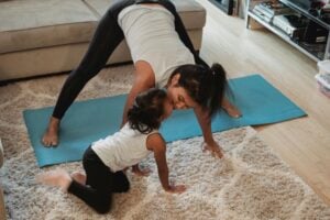 A mother doing yoga with her daughter