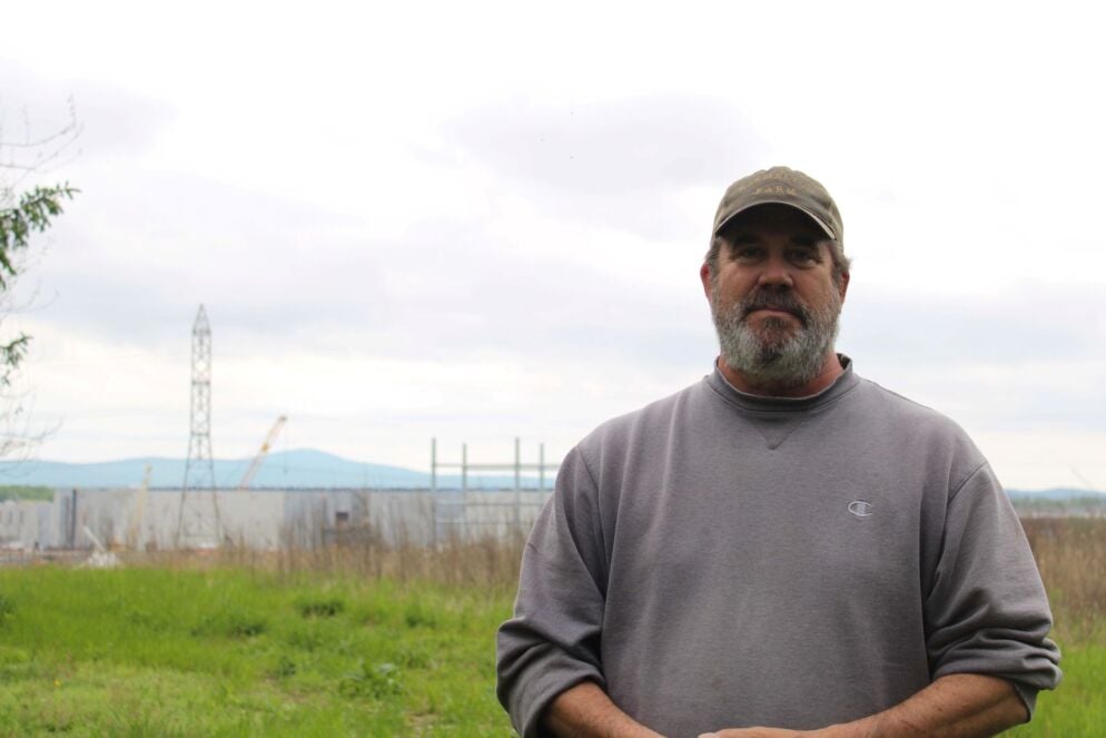 A data center construction site in the distance behind Steve Black in Adamstown, Maryland, in Frederick County