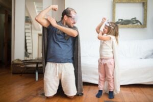 A father and daughter dressed as superheroes