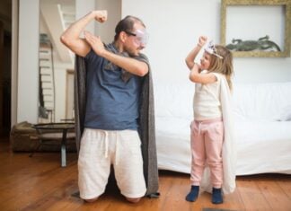 A father and daughter dressed as superheroes