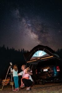 A family camps out under the stars