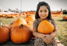 Girl holding pumpkin