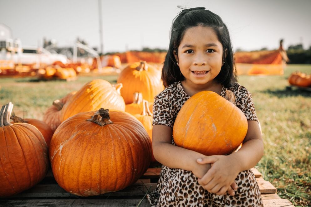 Girl holding pumpkin