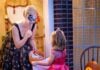 Young girl trick-or-treating at a woman's house