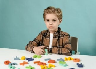 10 Signs Your Toddler May Need an Autism Evaluation Child with letter blocks